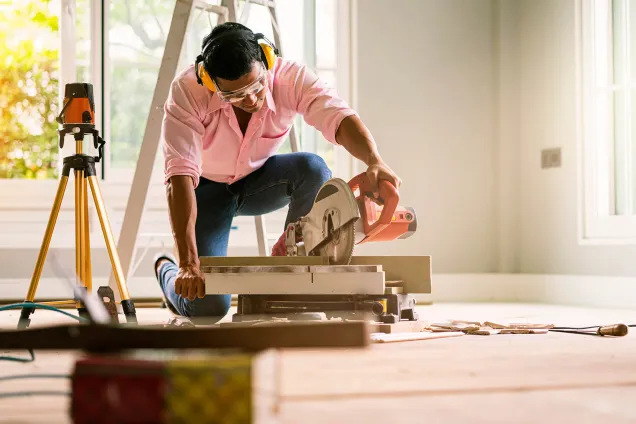 DIY man cutting floorboards 